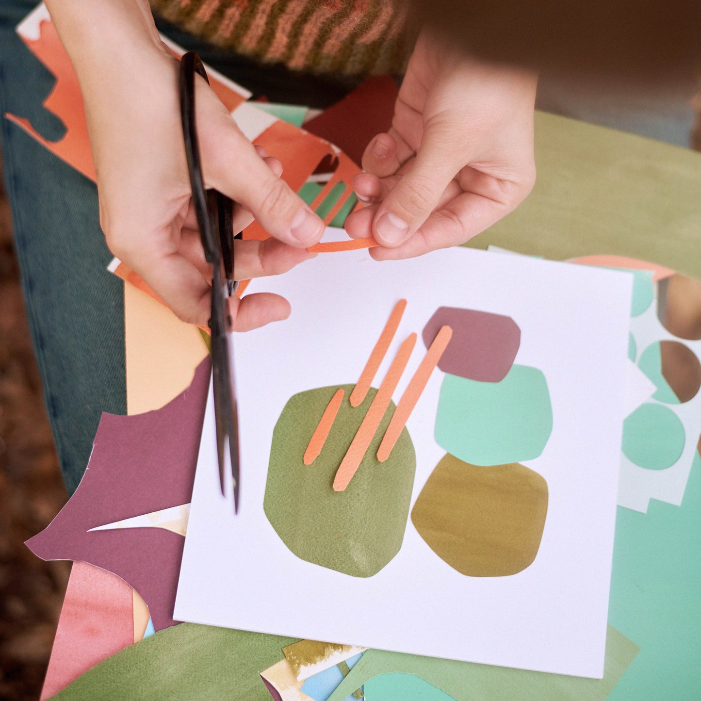 Anna cutting paper collages on the spot.