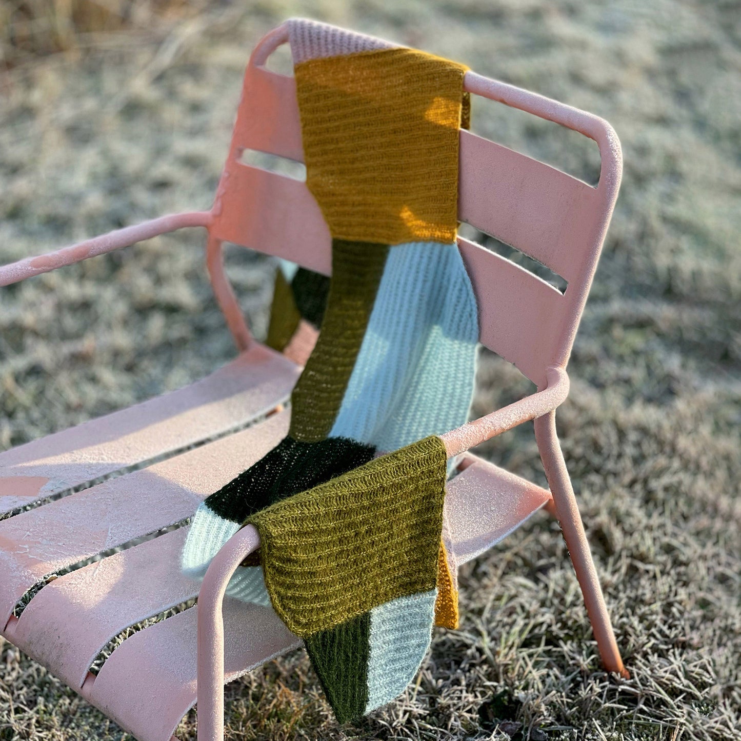 Forming scarf laying on a chair outside on an icy winter morning.