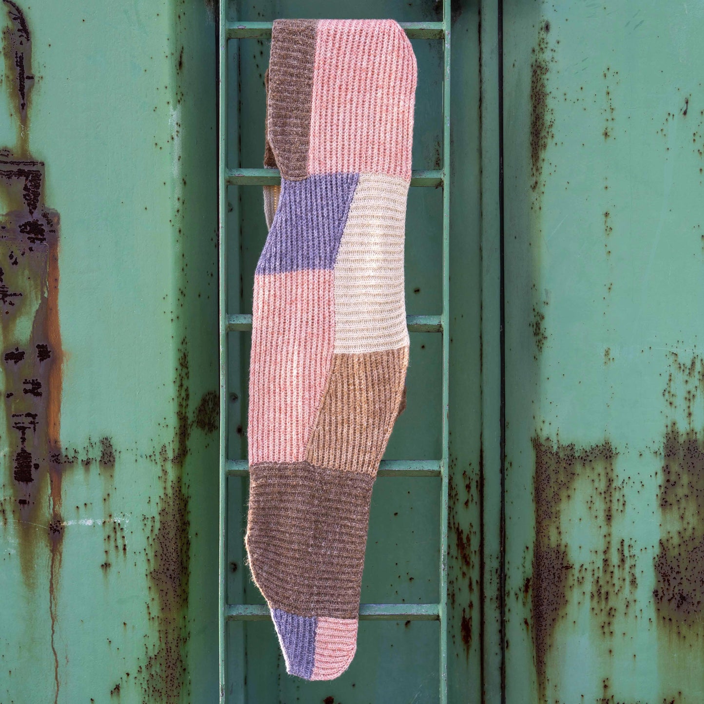 Forming Scarf hanging on a ladder in a green harbour spot.