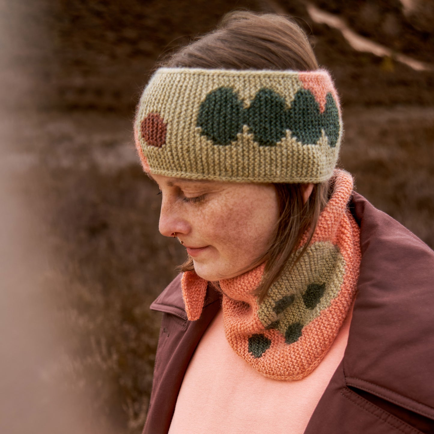 Ake modeling the Before Bloom Bandana and the In Full Bloom Headband from the book Intarsia Knits by Anna Husemann.