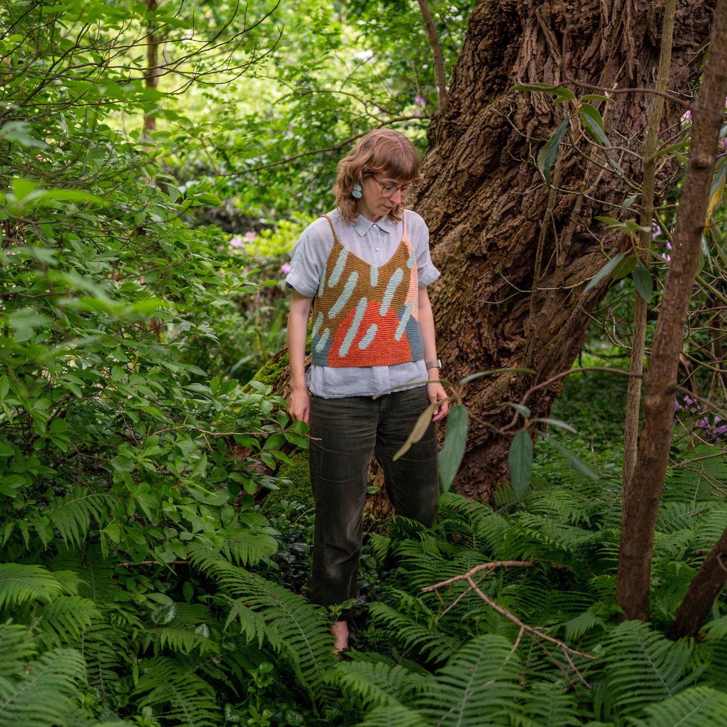 Anna Husemann wearing her Intarsia Top in a forest.
